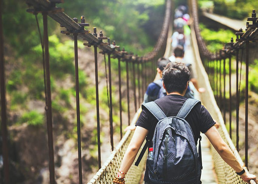A group of people walking on bridge