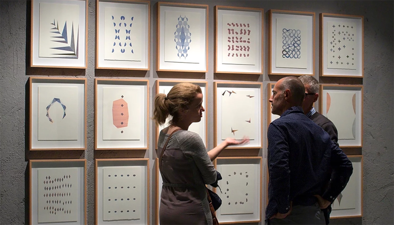 A man and a woman standing in front of a paints