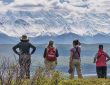 A group of people standing on top of a mountain
