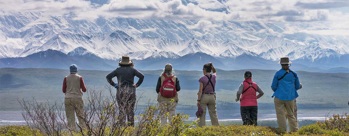 A group of people standing on top of a mountain